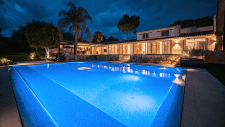 Luxury villa for sale in Marbella East with illuminated pool and elegant architecture