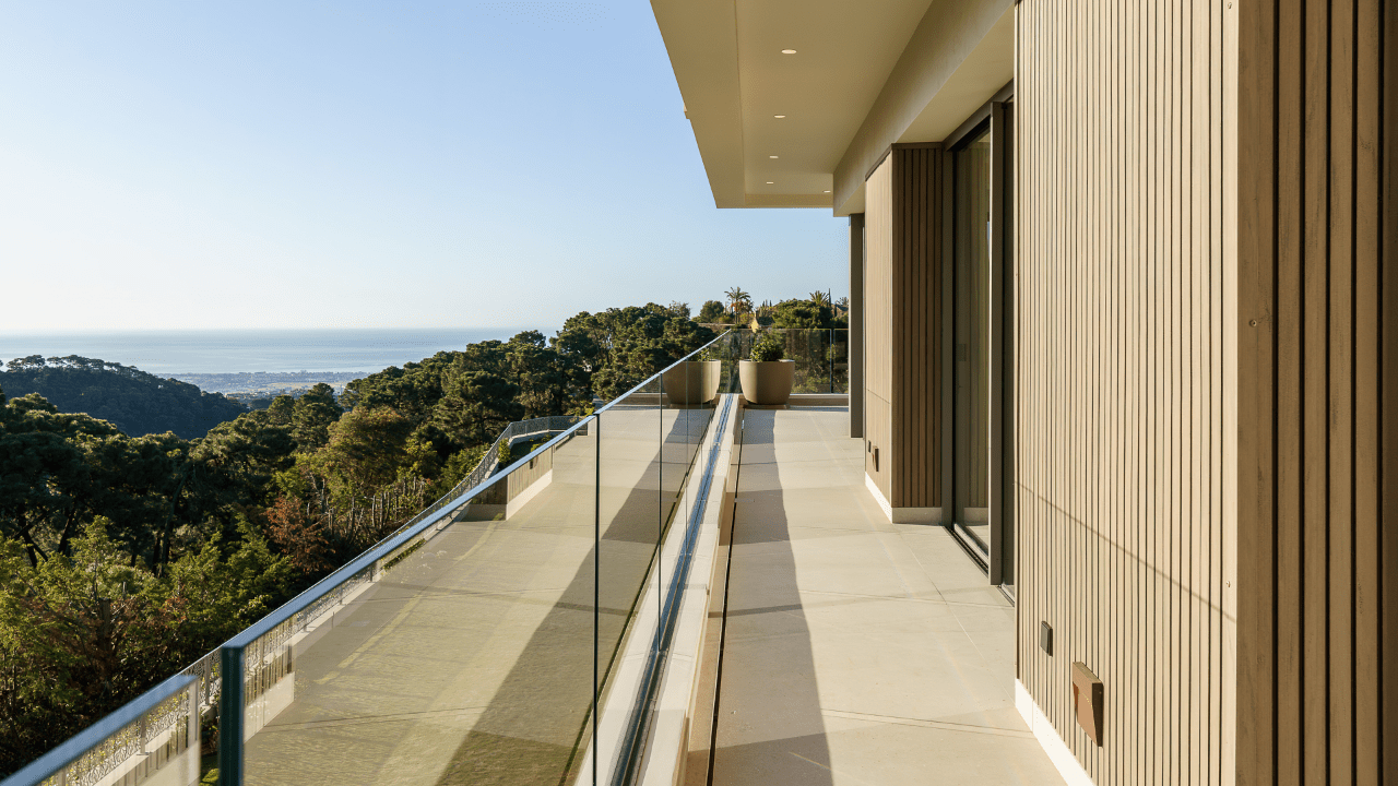 Panoramic view from a luxury villa balcony in La Zagaleta Marbella, showcasing Mediterranean sea views and modern architectural design