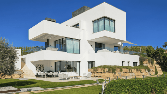 Modern villa for sale in Monte Mayor with sleek architecture, spacious terraces, and landscaped garden