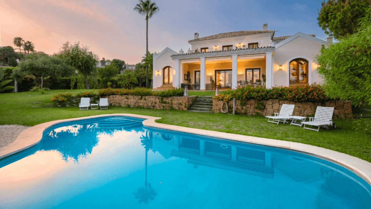 Elegant villa for sale in Los Flamingos, Benahavis with lush gardens, private pool, and classic Mediterranean architecture