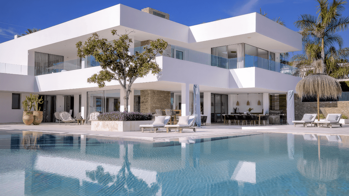 Modern luxury villa with sleek architecture, a spacious pool, and stylish outdoor living spaces in La Cerquilla, Nueva Andalucia