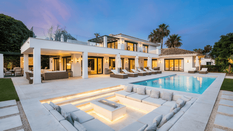 Luxury villa for sale in Nueva Andalucia Marbella with spacious pool and outdoor lounging areas