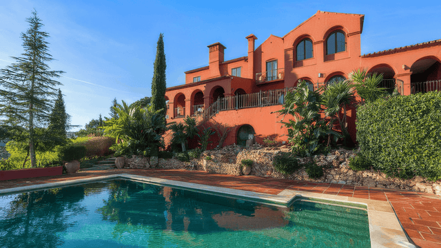 Luxury villa for sale in El Madroñal, Benahavis with private pool, lush gardens, and stunning Mediterranean architecture