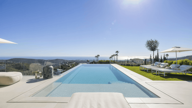 Luxury villa for sale in Monte Mayor Marbella with infinity pool, sea views, modern design, and sun loungers for relaxation